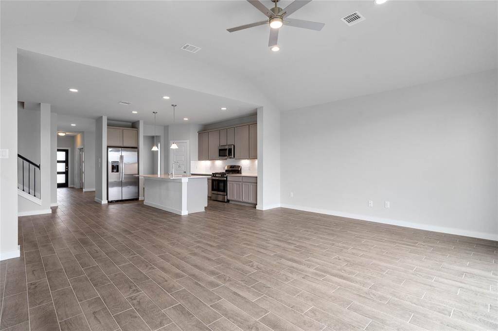 Additional view of this spacious family room looking to the kitchen!