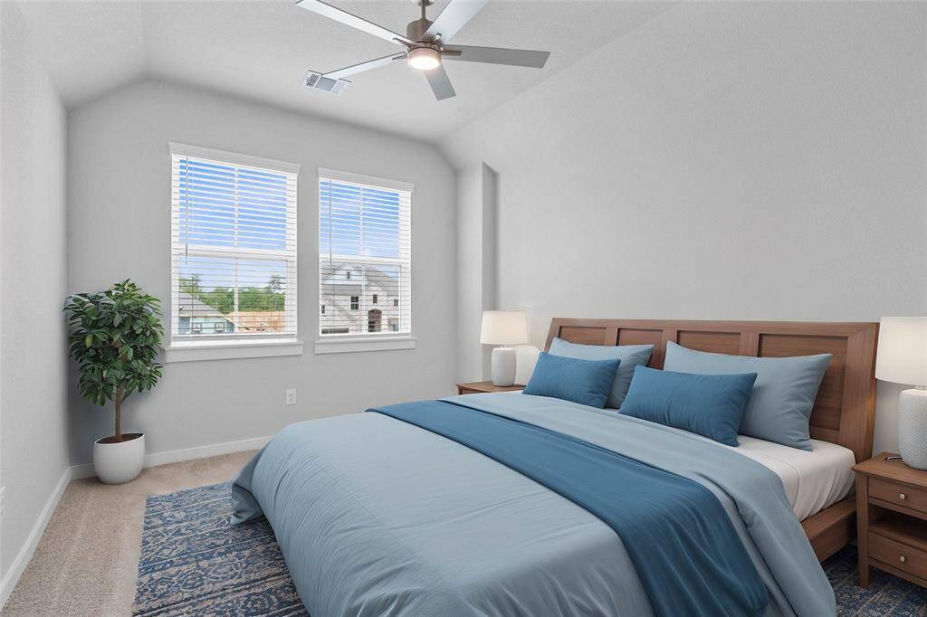 Secondary bedroom features plush carpet, custom paint, high ceilings, ample closet space, large windows with privacy blinds, and its private access to a secondary bathroom.