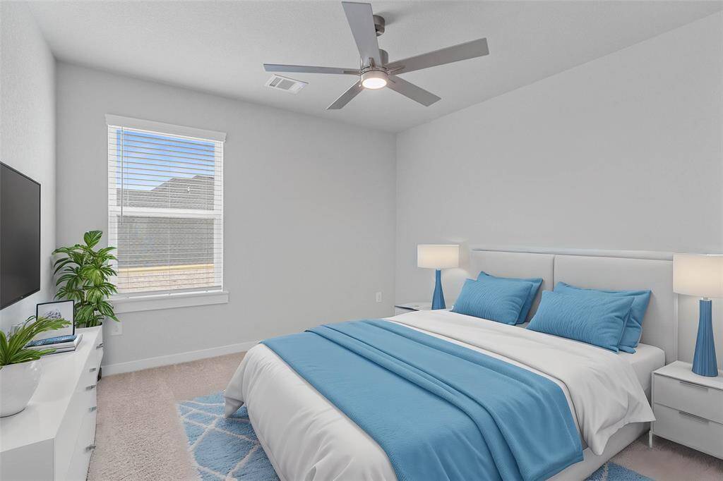 Secondary bedroom features plush carpet, custom paint, high ceilings, ample closet space, and large windows with privacy blinds.