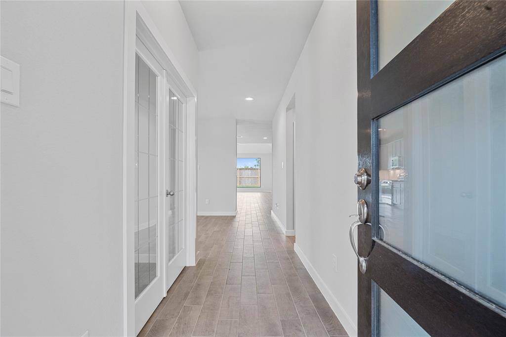 Welcome inside 3014 Knotty Forest Drive. As you enter, you are greeted by the beautiful front door, wood look tile flooring and recessed lighting!