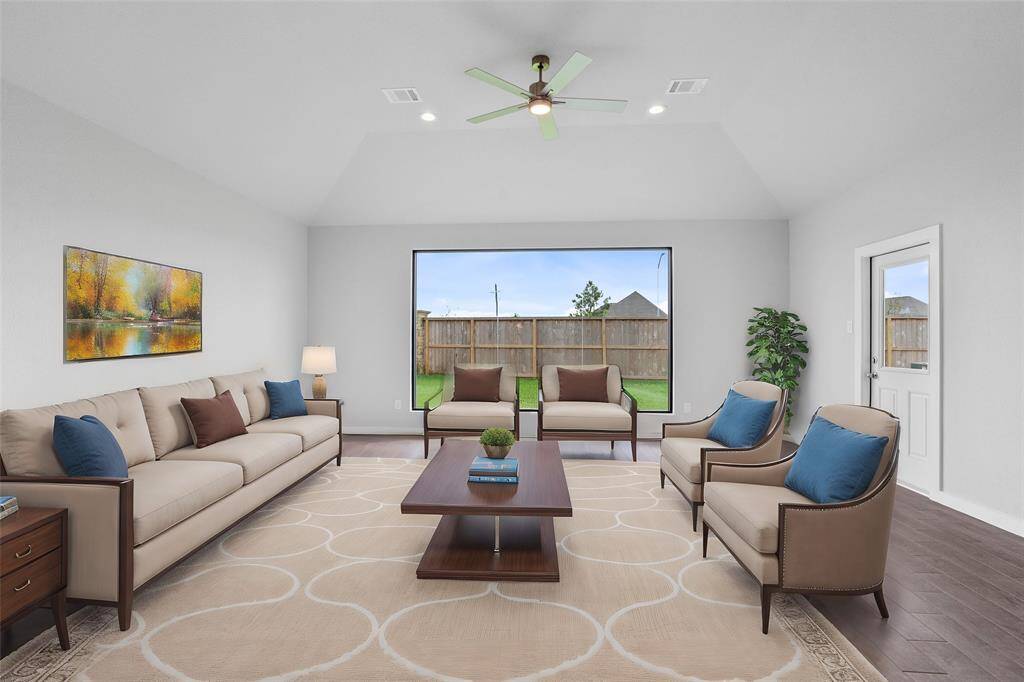Gather the family and guests together in your lovely family room! Featuring the large picturesque window, high ceilings, recessed lighting, ceiling fan, custom paint, and gorgeous tile flooring!