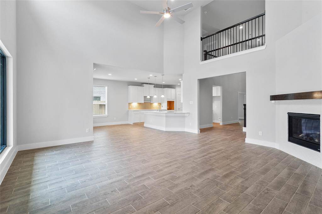 Additional view taken from the Family Room into the breakfast, kitchen and second story that overlooks the Family Room. The high ceilings are highlighted in this great space!