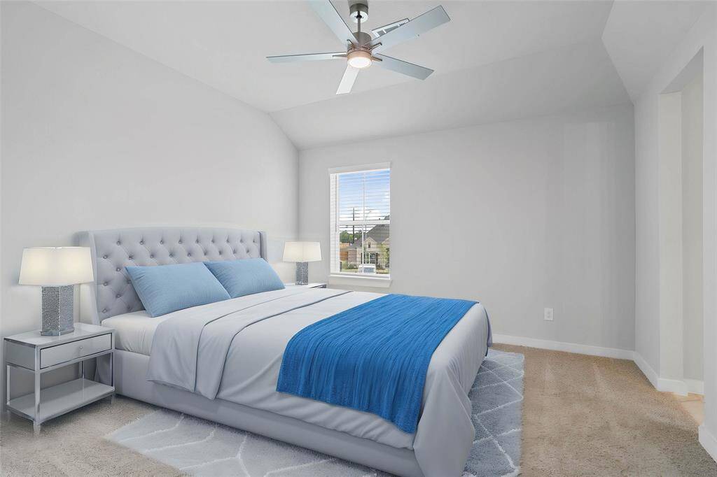 Secondary bedroom features plush carpet, custom paint, ceiling fan, closet space, large window with blinds, and its own private access to a secondary bathroom.