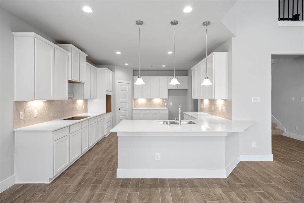 Another view of this beautiful kitchen featuring the extended cabinet for breakfast bar and the gorgeous pendant lighting!