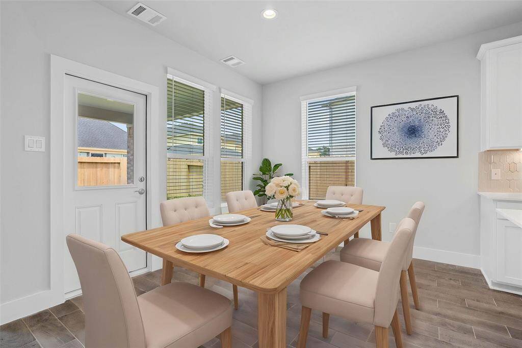 Make memories gathered around the table with your family and friends! This dining area features high ceilings, custom paint, recessed lighting, large windows with blinds, and patio door leading to the backyard.