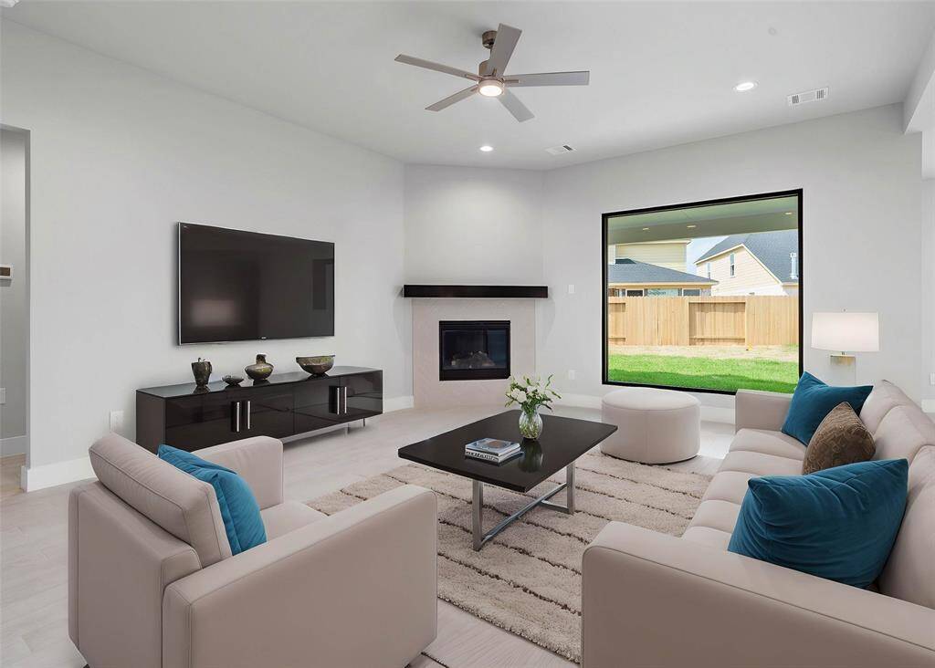 Gather the family and guests together in your lovely family room! Featuring a gorgeous fireplace with wood mantel and large picture window where you get to enjoy the outdoor scenery! Also featuring high ceilings with ceiling fan, recessed lighting, custom paint, and beautiful wood look tile floors.