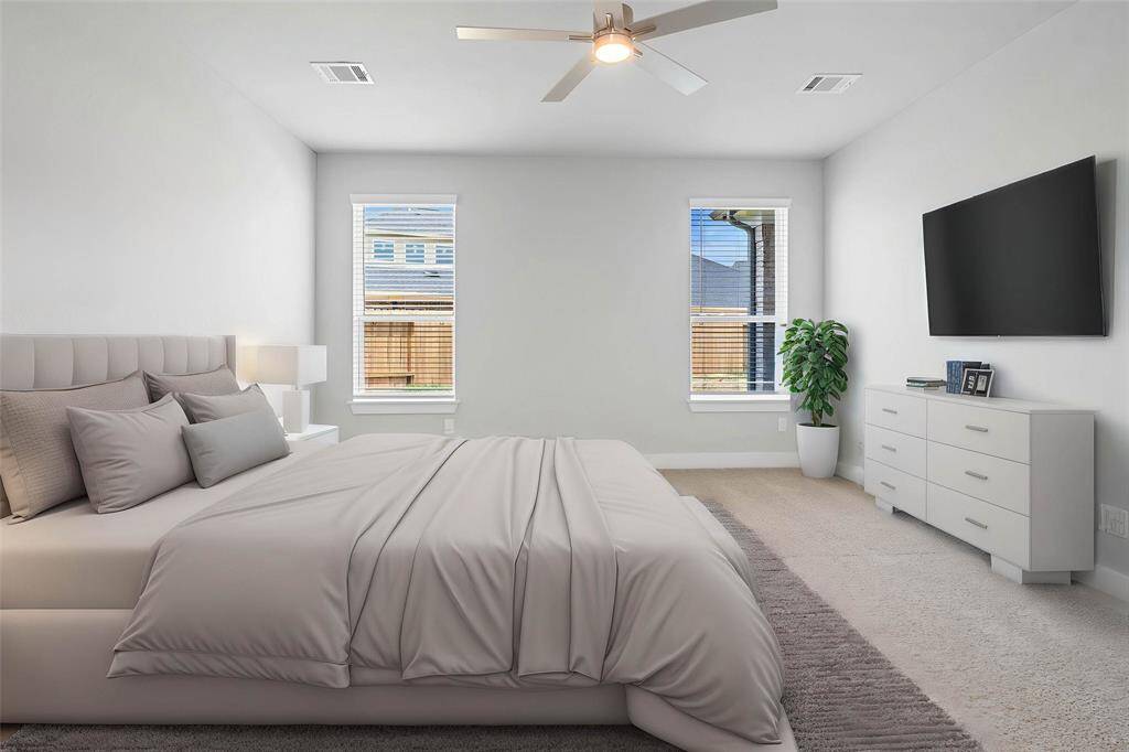 Come and unwind after a long day in this magnificent primary suite! This spacious room features plush carpet, warm paint, high ceilings with ceiling fan, and large windows with blinds.