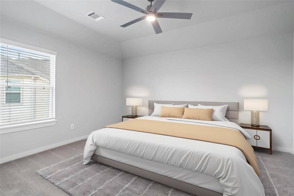 Secondary bedroom features plush carpet, custom paint, ceiling fan with lighting, large window with blinds, and closet space.