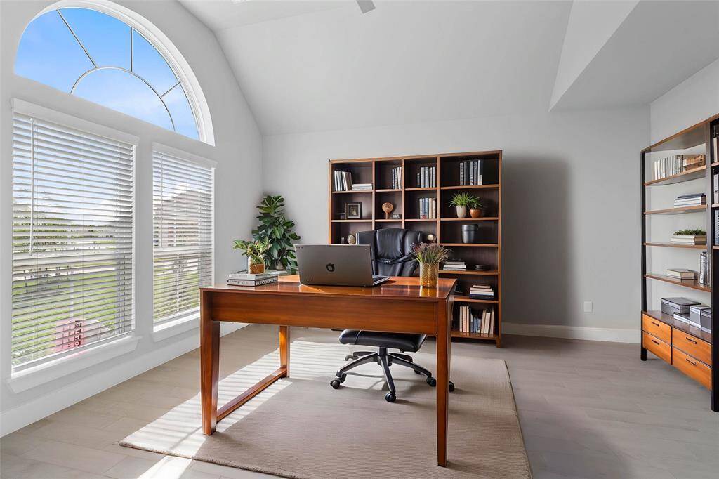 Quietly nestled in front of the home is the handsome home office! Featuring wood look tile flooring, high ceilings, large beautiful windows with blinds, and custom paint!