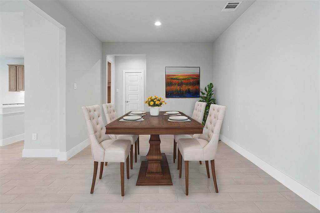 Make memories gathered around the table with your family and friends! This dining room features high ceilings, recessed lighting, custom paint, and gorgeous wood look tile flooring.