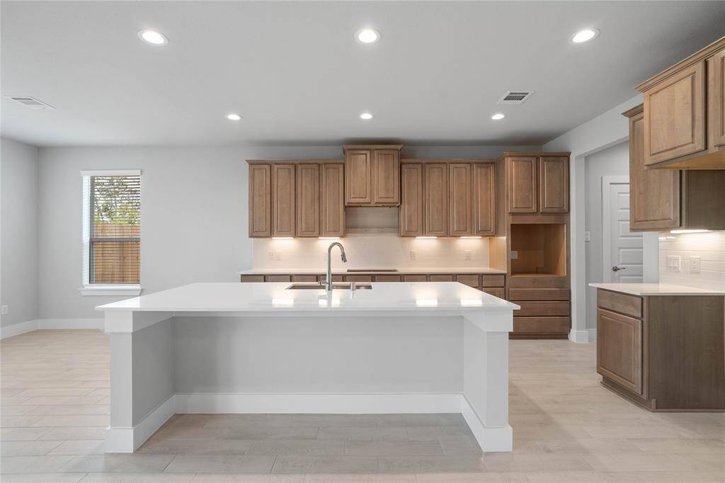 Additional view of this spacious kitchen featuring the large kitchen island with room for breakfast bar, and breakfast area on the left of kitchen.