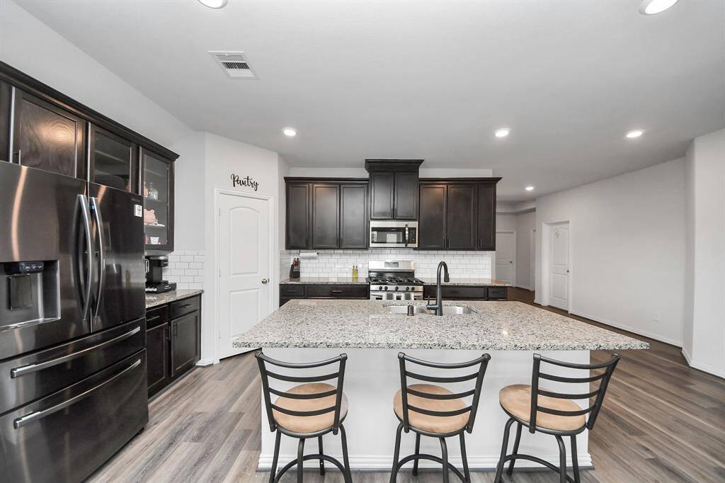 Whole kitchen view, very spacious pantry.