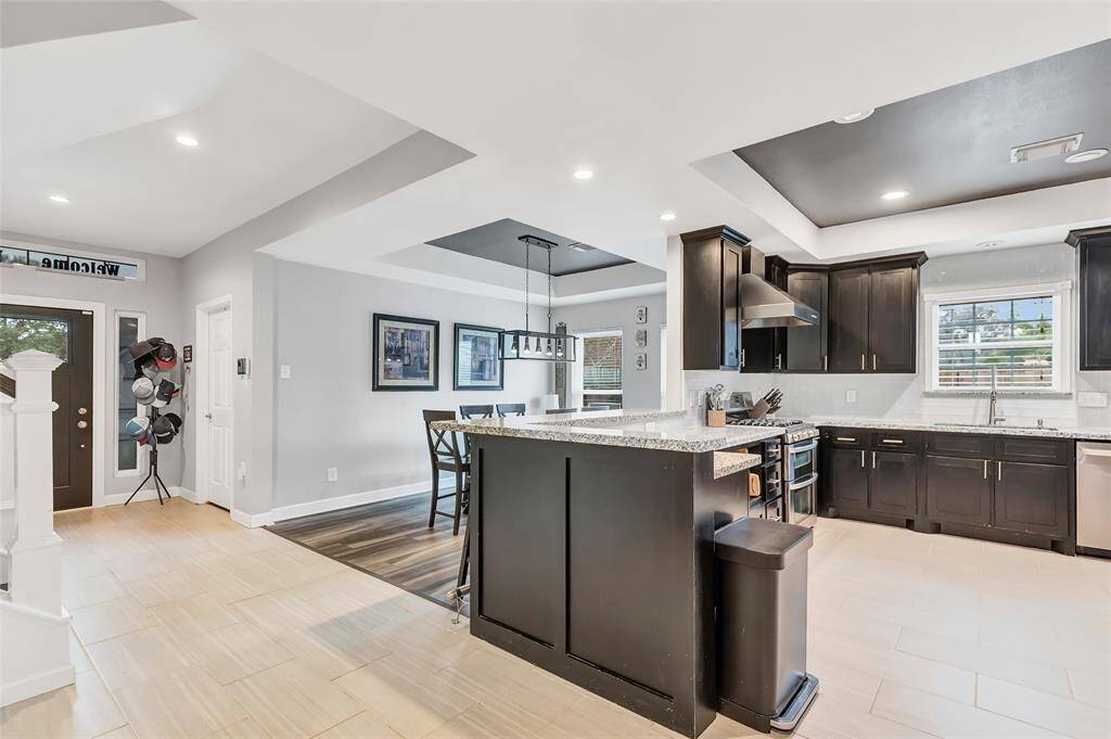 Plenty of counter top and bar space in this kitchen with updated cabinets and granite counter tops.