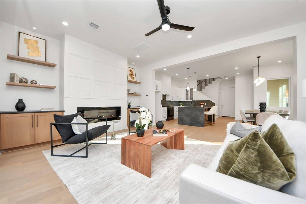 The living room features a 60-inch wide by 21.5-inch high electric fireplace to keep you warm, complemented by an accent wall that adds character to the space. The realistic flames can be customized with either clear crystals or wooden accents, allowing you to create the perfect ambiance.