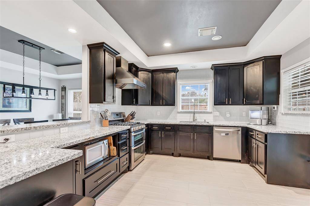 Check out all that counter space and the gas range. A perfect view of the backyard while washing dishes.