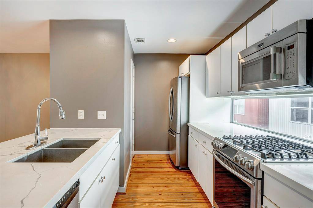 Your kitchen has Beautiful Stile stone counter tops, gleaming wood floors, All your SS appliances,large pantry gas cooking and a extra closet for more storage.