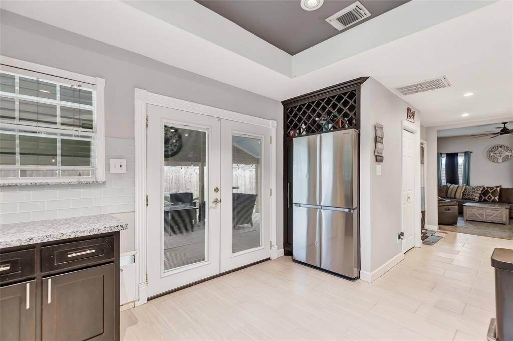 Double French Doors leads to the back yard. And a huge refrigerator tucked away with storage space.