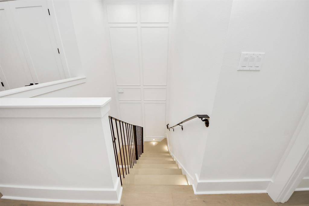 A striking 35-foot accent wall grabs your attention as you reach the second floor, leading you toward the spacious primary suite.