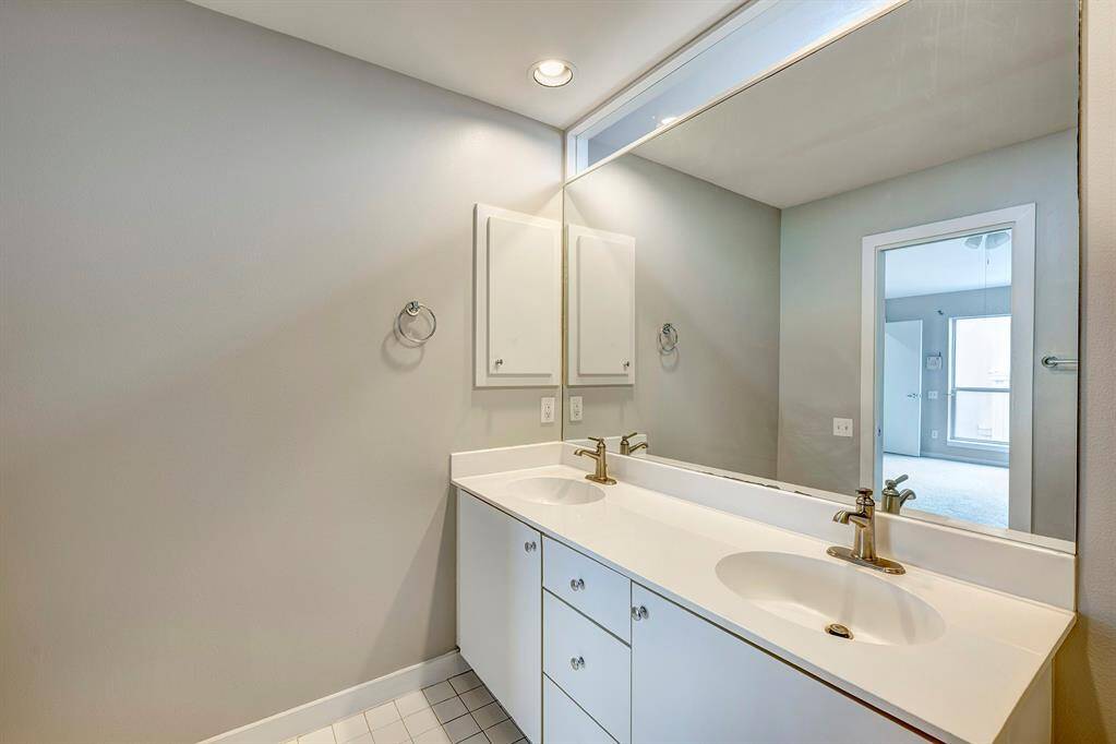 Primary bath offers dual cultured marble vanities, tile floor and Euro separate tub and shower.