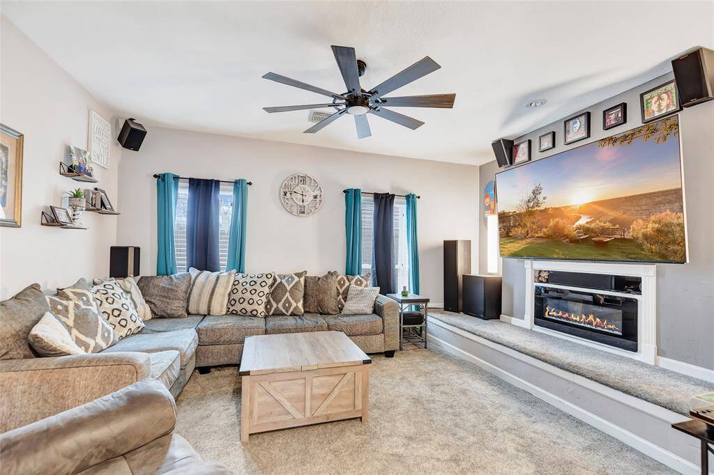 Huge living room with an amazing fire place set up. Surround Sound speakers and plenty of space for a large tv.