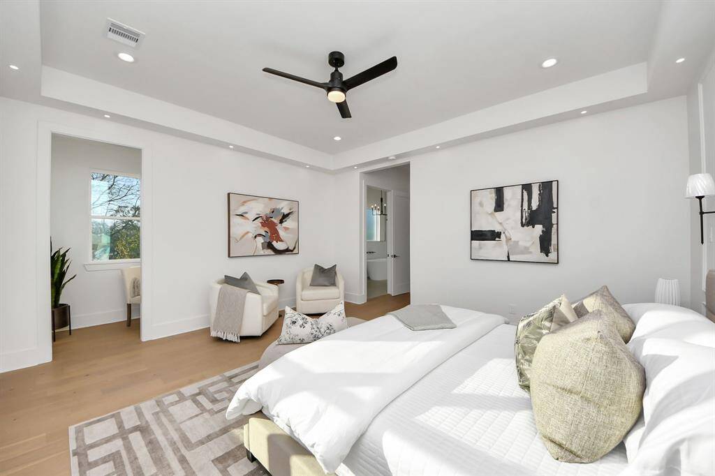 The primary suite is bright and airy, with abundant light highlighting the space—from the 6-inch can lights to the 2-inch accent lights, setting the perfect tone for the room. Just ahead to the left, you'll notice a cozy study nook