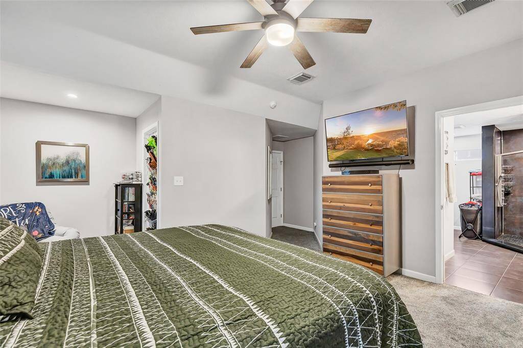 Primary bedroom with a reading area, walk in closet, and primary bathroom.