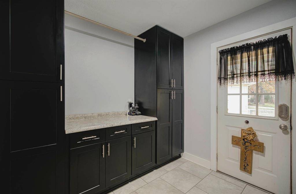 Laundry room w  door leading to patio