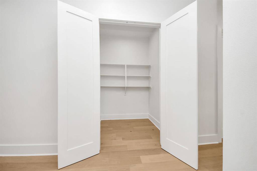 MASSIVE hallway closet with shelving and open space offers plenty of room for your vacuum, floor care items, cleaning supplies, and more, ensuring everything stays neatly organized and easily accessible.