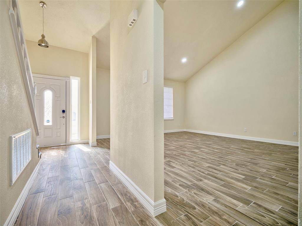 Wood looking tile floors through out common areas. And look at the ceiling height in this Great Room