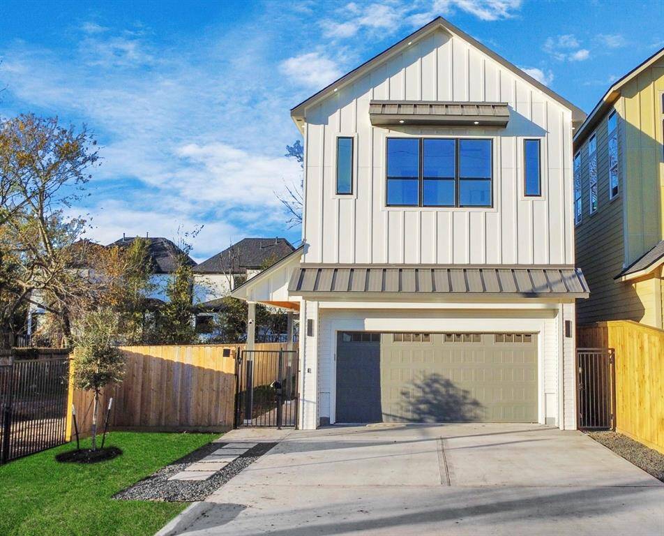 The grand exterior of the home features five windows with sleek metal awnings, adding both style and protection.