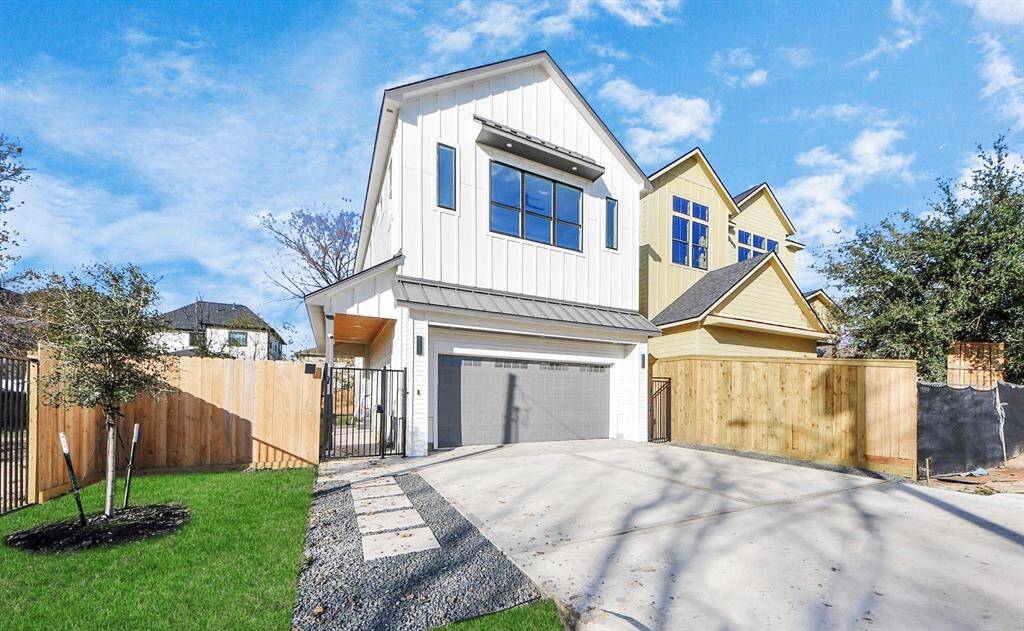 The accent-paneled garage creates depth and texture, while two secured metal gates on either side of the home provide easy access to both sides of the property.