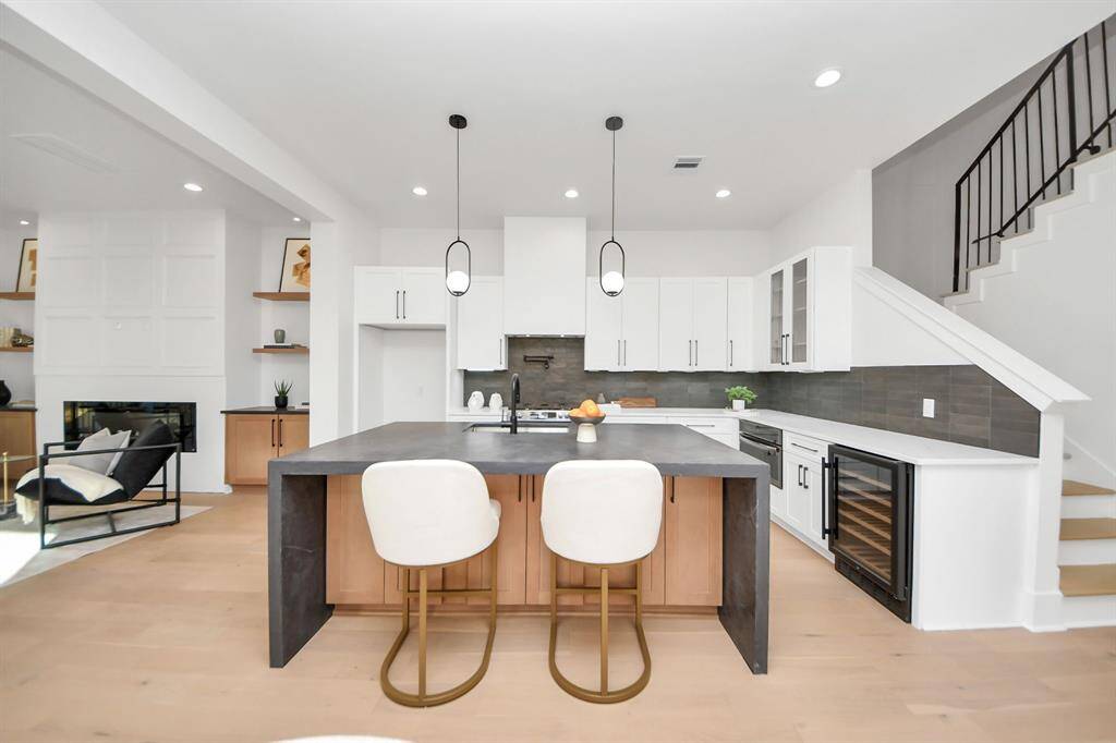 The kitchen boasts every feature you could imagine, from the stunning 3CM leather waterfall island, which serves as both a focal point and a functional centerpiece, to the under-island cabinets offering additional storage and convenience.