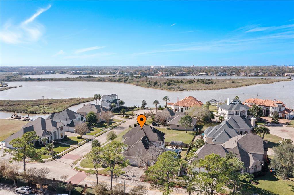 This beautiful home is located in a picturesque neighborhood with well-maintained homes near a serene waterfront. The area features lush greenery, spacious properties, and offers a peaceful, scenic view of the water, ideal for a tranquil living environment.