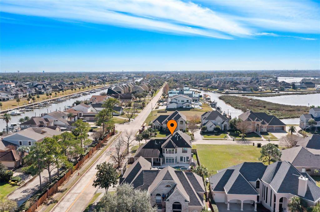 Aerial view of the spacious, upscale neighborhood of Star Point. The area is near a canal, offering waterfront access and scenic views. Ideal for buyers seeking a serene, well-maintained water community.