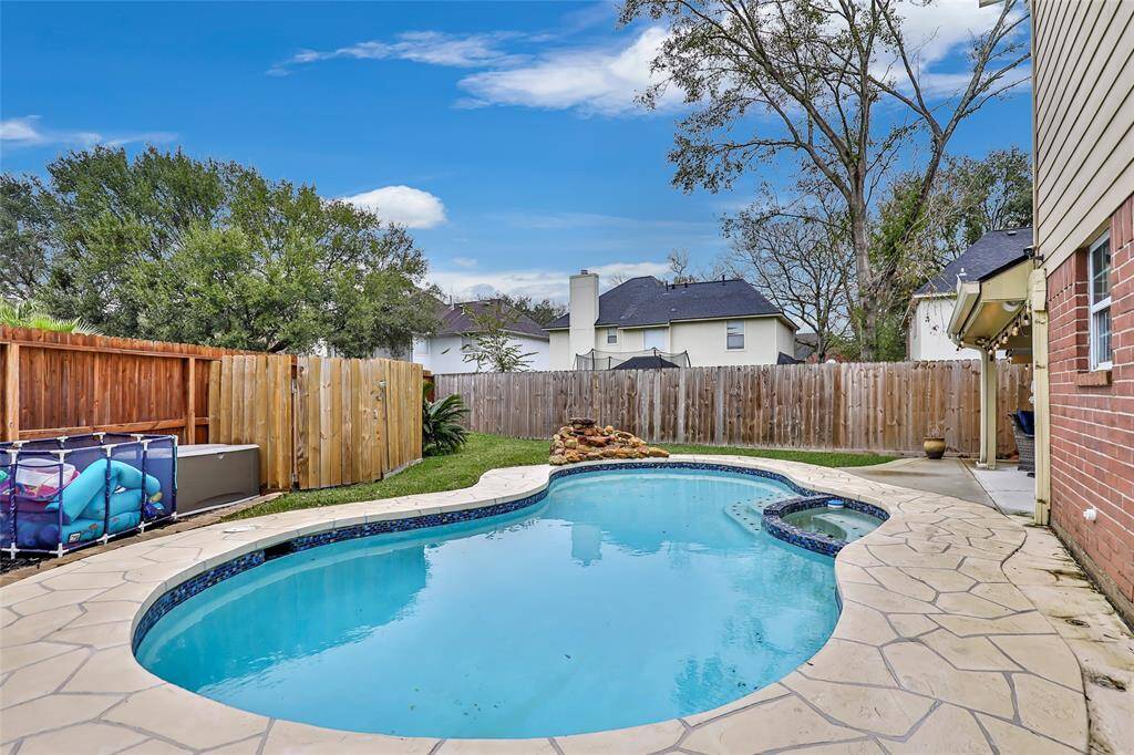 Awesome inground pool with hot tub combo. Waterfall feature tops it off.
