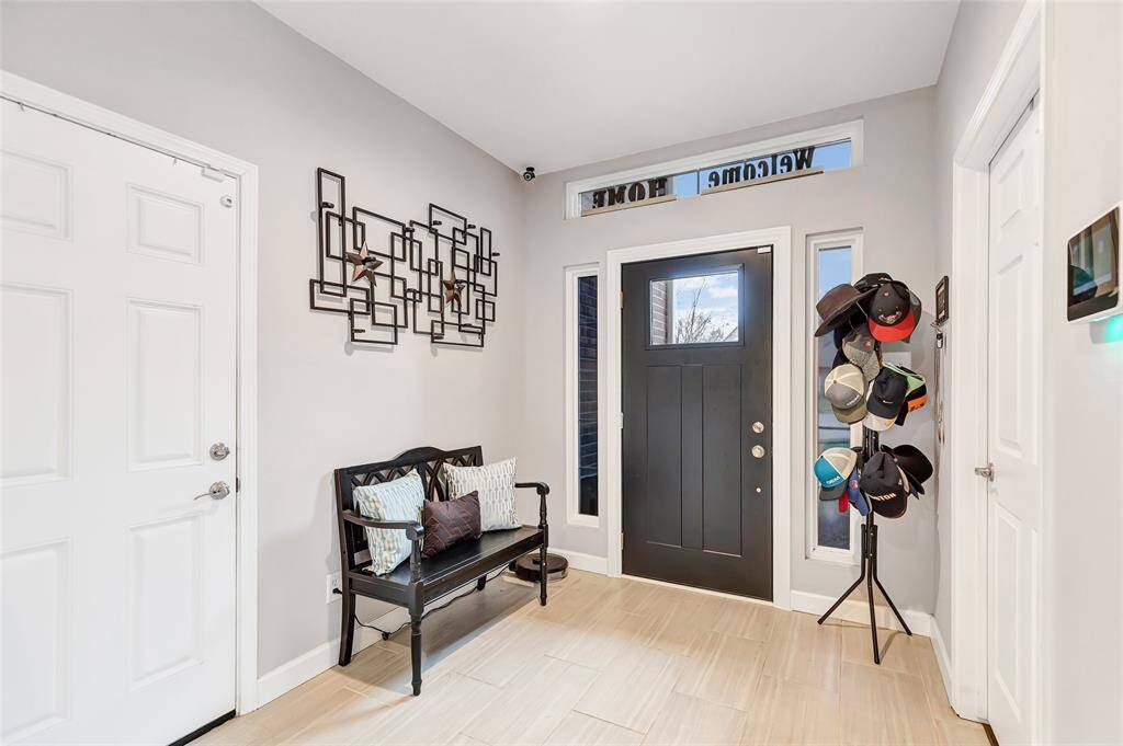 Upon entering the home you have the garage to the right and a Office / Bedroom to the left.