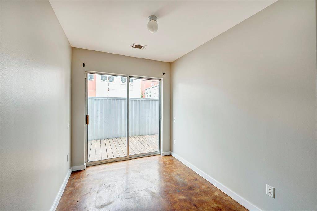 Third bedroom/bonus room with exterior views and access to the patio/deck.