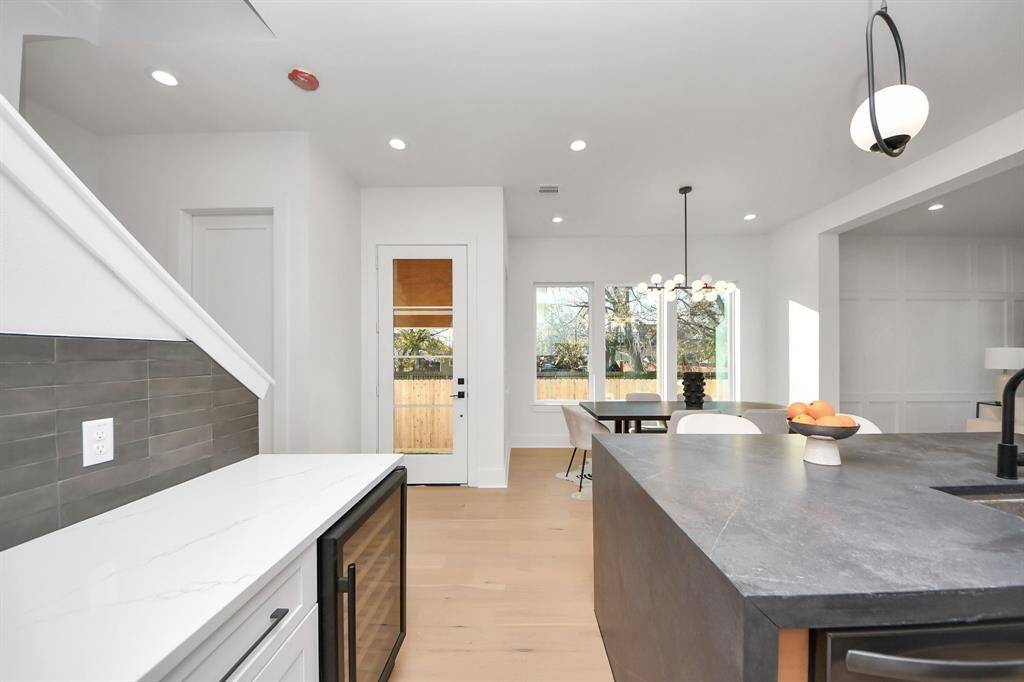 The upgraded 24-inch wine fridge seamlessly transitions from the dining room to the island, offering a stylish space to entertain. With a built-in capacity for 51 wine bottles, it provides ample storage. If you're not a wine lover, the removable pull-out shelves are perfect for storing sodas or even essential oil towels, making this fridge a versatile addition to your home.