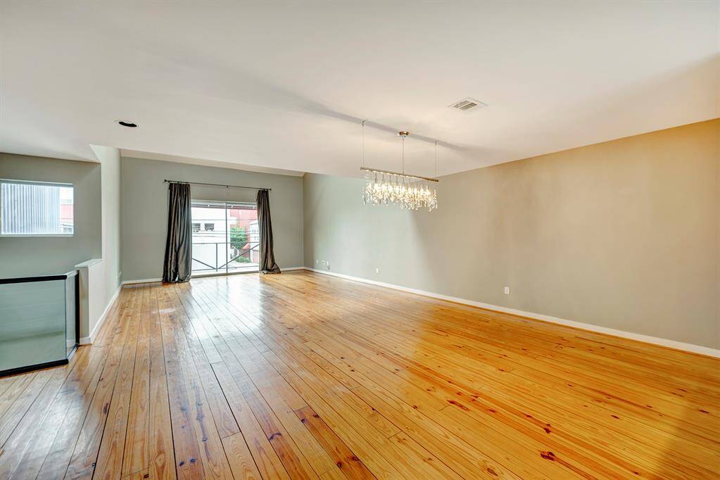 Soaring ceilings, rustic gleaming pine floors and ceiling fan, make this open living area a fantastic place to entertain.