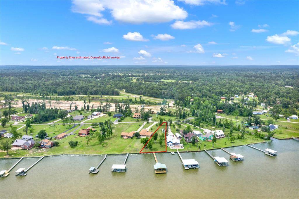 Pie shaped lot with a garage and storage unit with ample space to build a home. Enjoy the boathouse, fish or swim off the pier all while you build your dream home here.