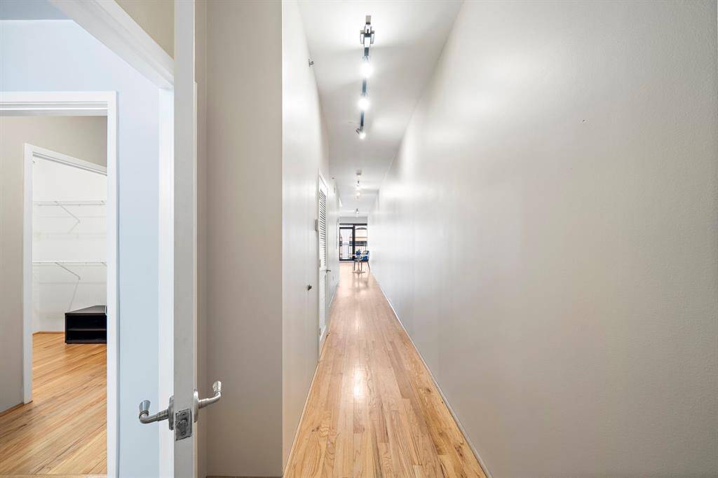 When you enter the unit there is a wonderful gallery wall with track lighting. A display of collected art would be great here. Bathroom door to the left.