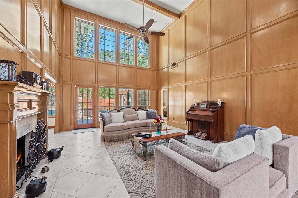 This inviting space offers the perfect sanctuary for relaxation and quality time with family. Bathed in natural light, the sun-drenched living area features soaring two-story ceilings that create an open and airy atmosphere.