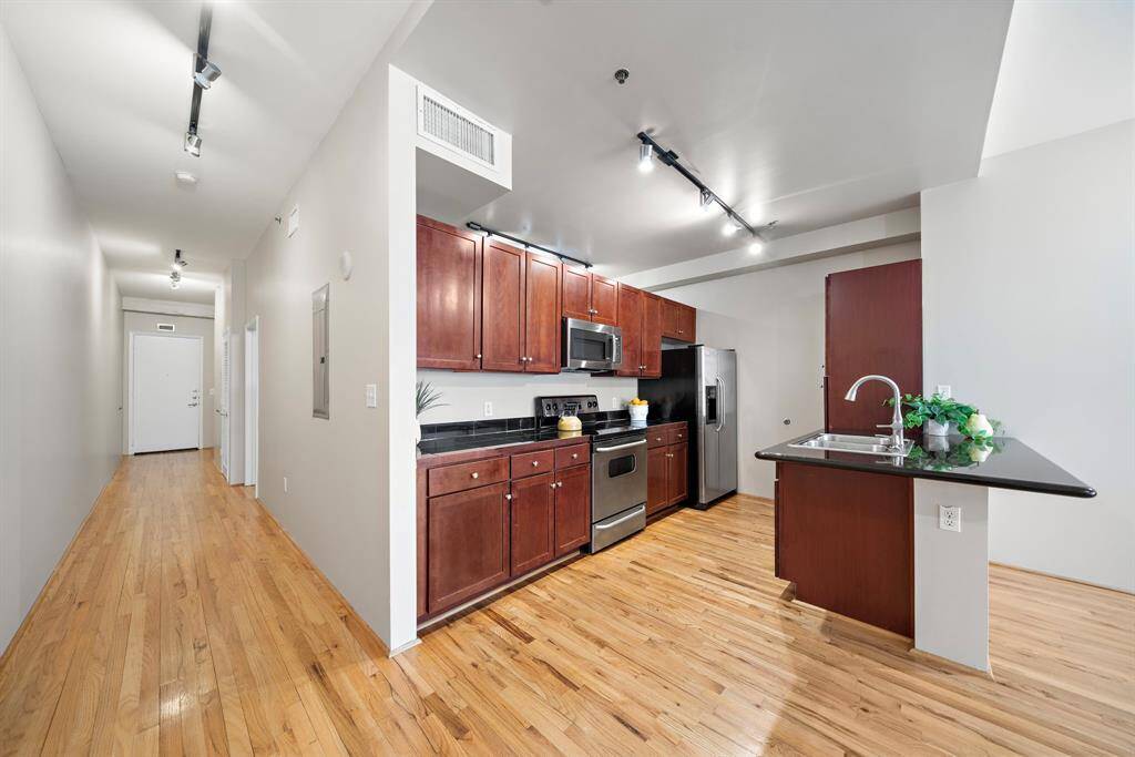 A closer look at the kitchen. There are tall pantry cabinets next to the island.