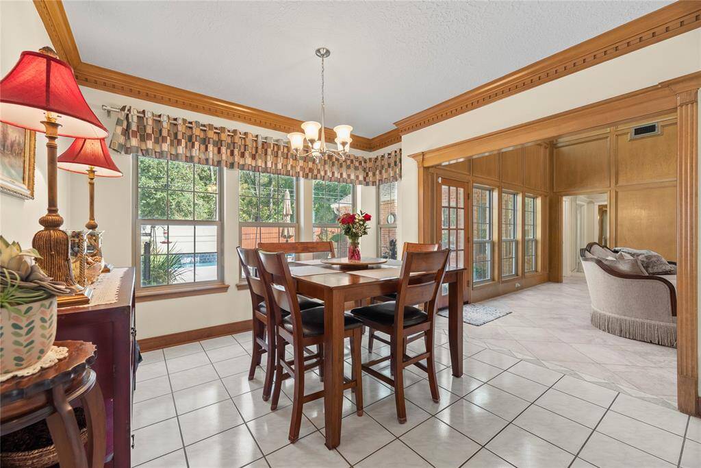 Sunlight streams through expansive windows, illuminating the picturesque view of the backyard, while sitting in your breakfast area.