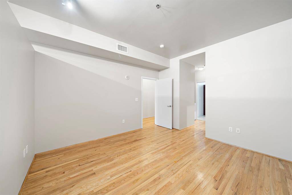 Another view of the bedroom with the bathroom towards the right.