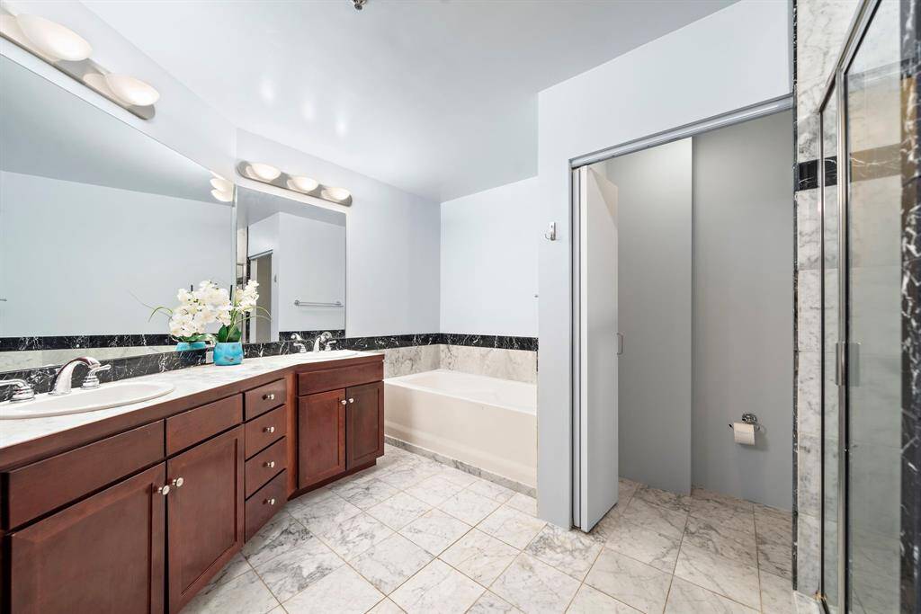 The bathroom has double sinks, a large expanse of counter space, a soaker tub and walk-in shower.