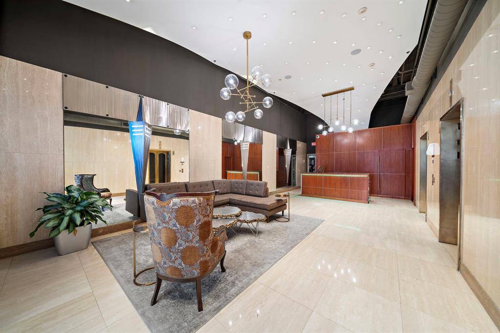 The lobby had an extensive remodel a few years ago. There is on-site management and a porter. The hallway to the left of the desk leads to the attached garage.