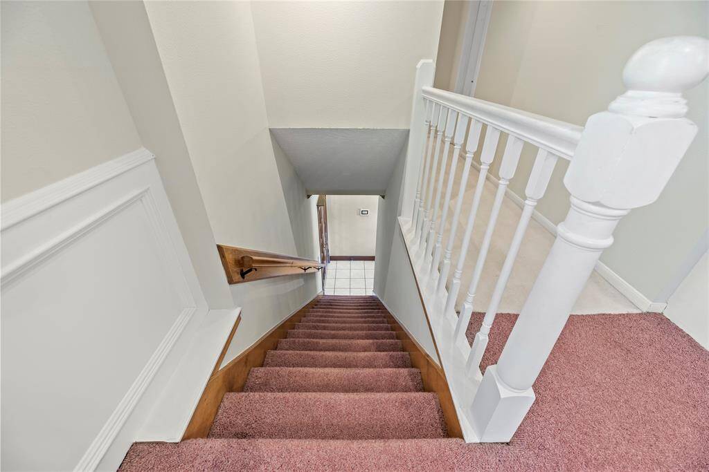 The second staircase, seamlessly connecting the kitchen to the game room, offers unparalleled convenience and accessibility.
