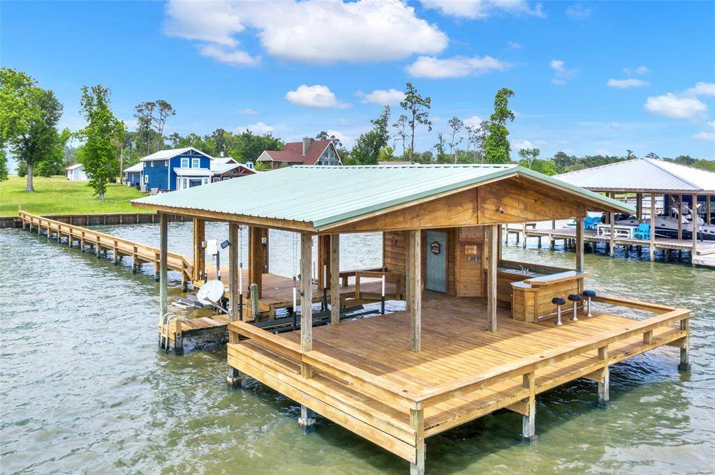 Boathouse includes a boat slip, two jet ski slips, large deck area and outdoor kitchen and bar area with storage. Plenty of room to enterain, fish, swim and more!