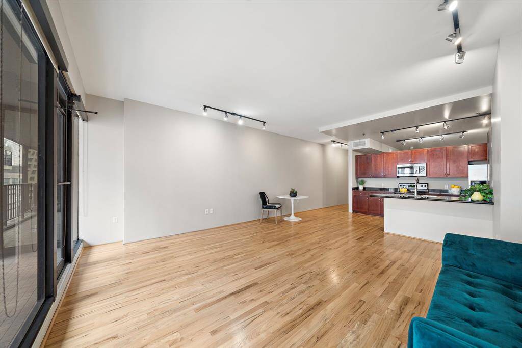 Many possibilities for furniture arrangement. The wall of windows includes roller shades for privacy.